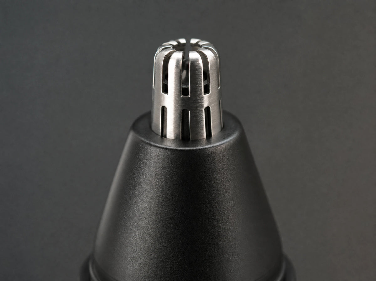 Macro of the steel cutting barrel rising out of the rounded black guard
